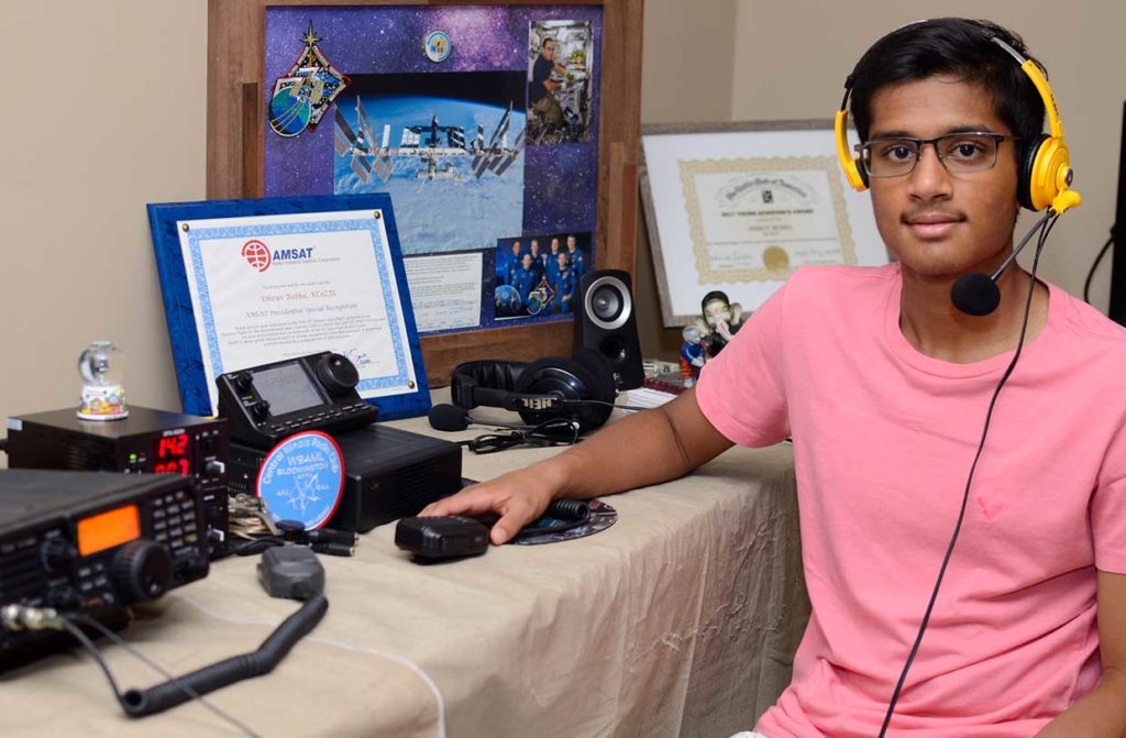 Photo: Sateesh Nallamothu Dhruv Rebba (KC9ZJX) with memorabilia from his ham radio contact with astronaut Joe Acaba (KE5DAR) onboard the International Space Station.